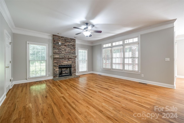 unfurnished living room featuring a fireplace, light hardwood / wood-style flooring, and ornamental molding