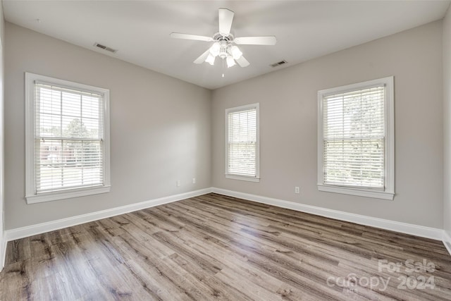 unfurnished room with ceiling fan, light hardwood / wood-style flooring, and plenty of natural light