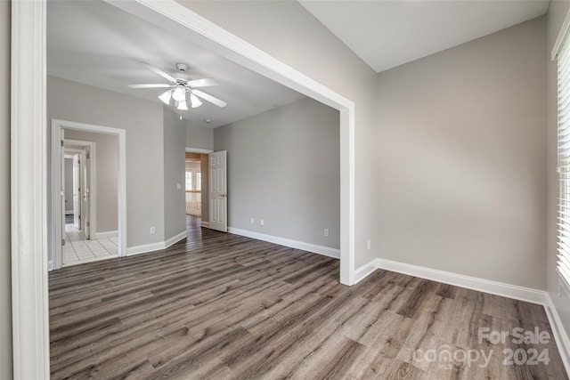 empty room with ceiling fan and wood-type flooring