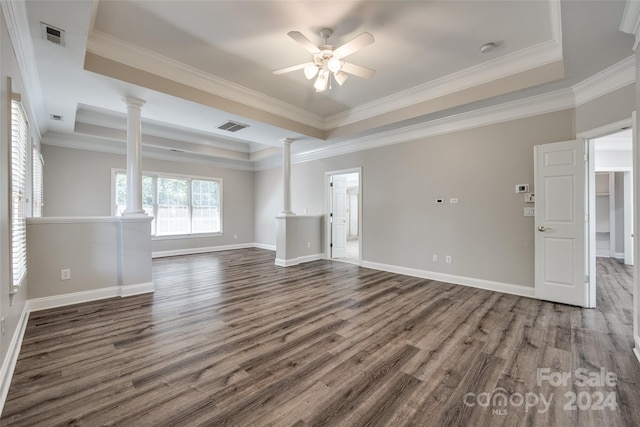 unfurnished living room featuring ceiling fan, a tray ceiling, ornamental molding, and wood-type flooring