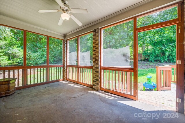 unfurnished sunroom with ceiling fan