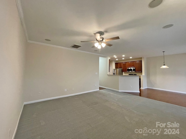 unfurnished living room with crown molding, carpet floors, and ceiling fan