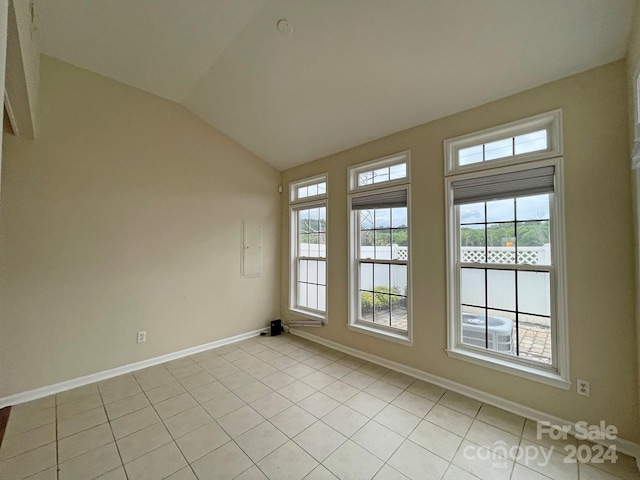 tiled empty room with vaulted ceiling