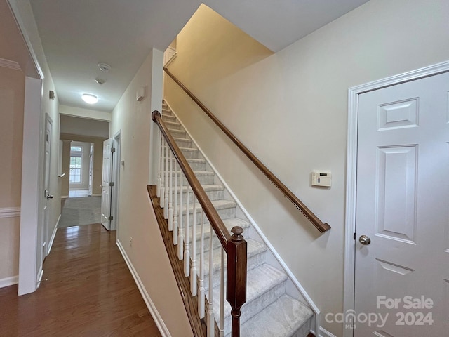 staircase featuring hardwood / wood-style flooring