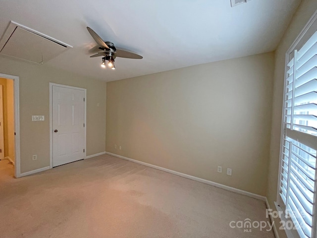 unfurnished bedroom featuring light colored carpet and ceiling fan