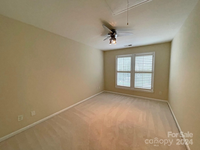 empty room featuring light carpet