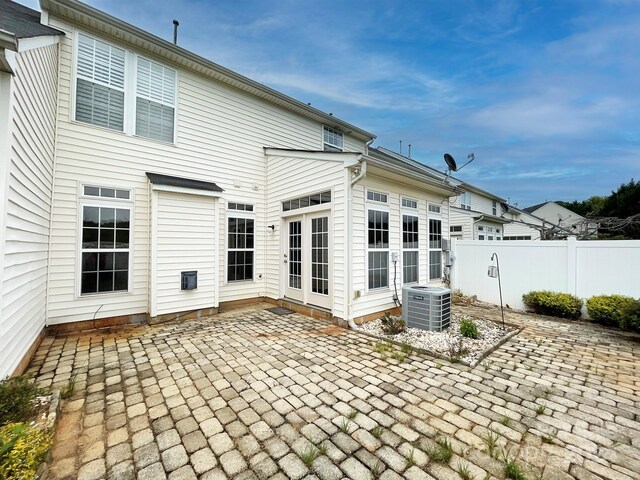 rear view of property with central AC and a patio area