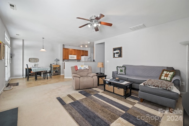 living room with light carpet and ceiling fan