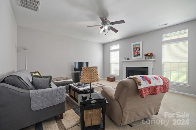 carpeted living room featuring ceiling fan