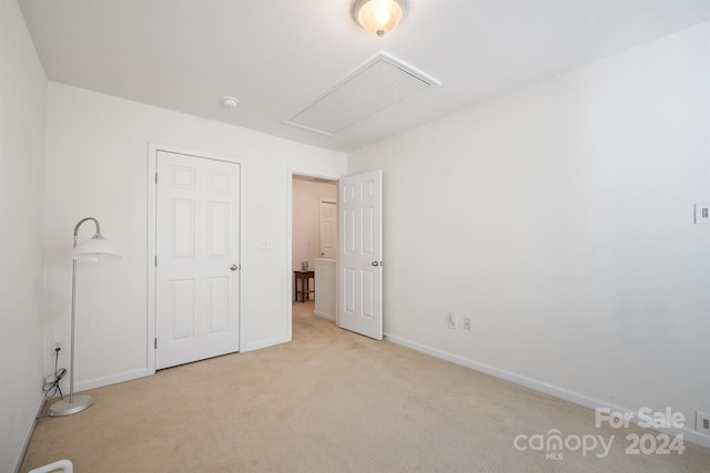 unfurnished bedroom featuring light carpet