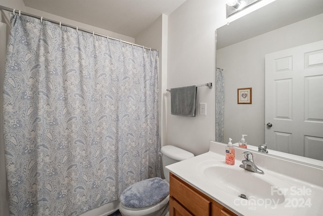 bathroom featuring toilet and vanity