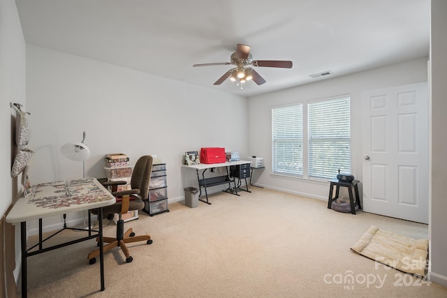 home office featuring light carpet and ceiling fan