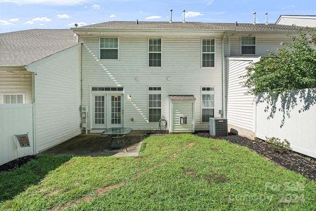 back of property featuring central AC, a patio area, and a lawn