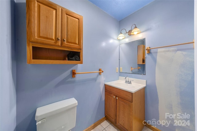 bathroom featuring vanity, toilet, and tile patterned floors