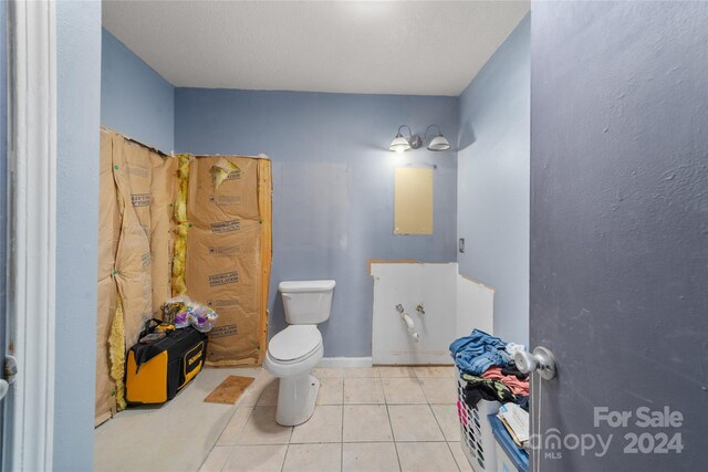 bathroom featuring tile patterned floors and toilet