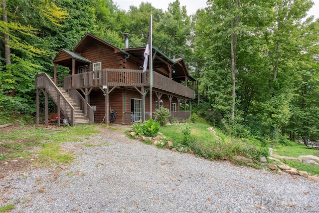 back of house featuring a wooden deck