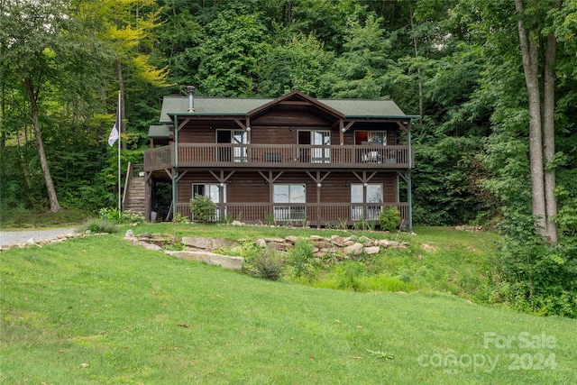 back of house featuring a deck and a yard