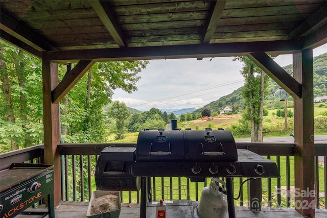 wooden terrace featuring grilling area