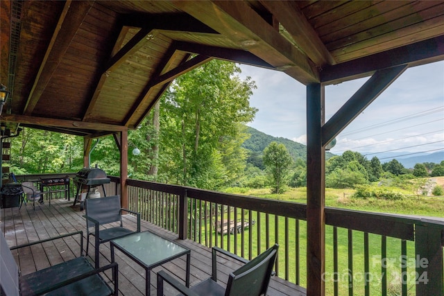 wooden terrace with a lawn