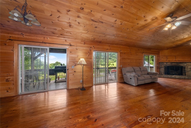 unfurnished living room featuring vaulted ceiling, a fireplace, wooden ceiling, ceiling fan, and hardwood / wood-style floors