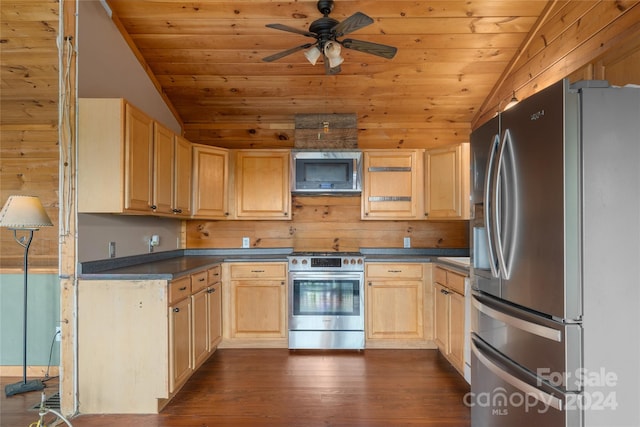 kitchen featuring light brown cabinetry, appliances with stainless steel finishes, lofted ceiling, and ceiling fan