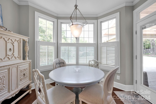 dining space with crown molding and dark hardwood / wood-style flooring