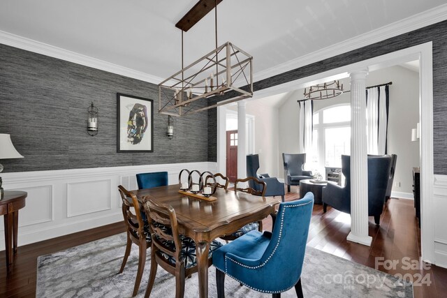 dining area with ornamental molding, dark hardwood / wood-style flooring, and ornate columns