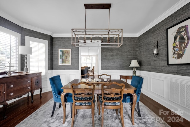 dining room featuring hardwood / wood-style flooring and crown molding