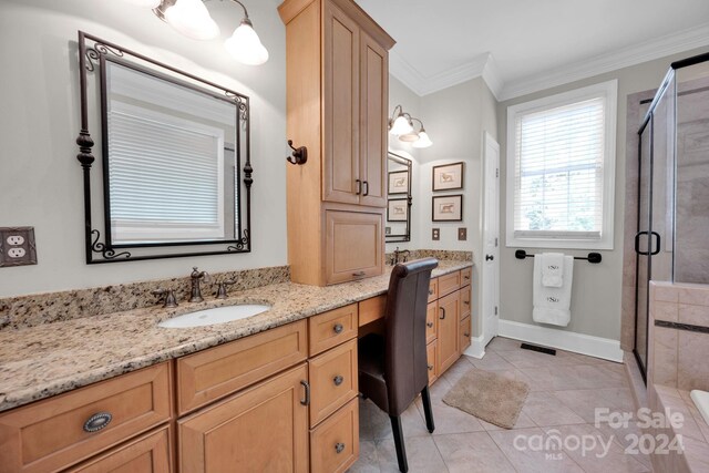 full bath with tile patterned floors, crown molding, vanity, a shower stall, and baseboards