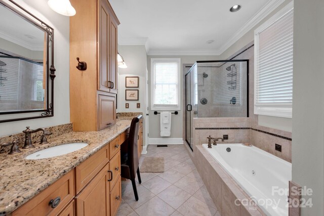 bathroom featuring tile patterned floors, vanity, a garden tub, a shower stall, and ornamental molding