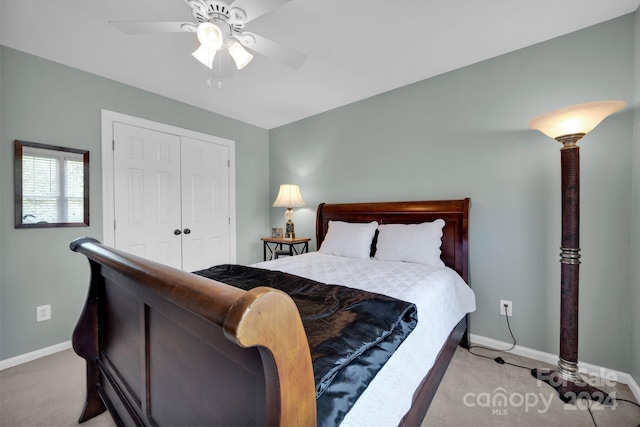 carpeted bedroom featuring a closet and ceiling fan