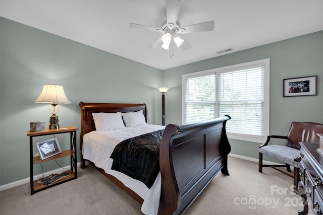 bedroom with light carpet and ceiling fan