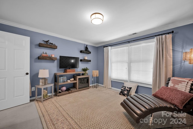 sitting room with light colored carpet and ornamental molding