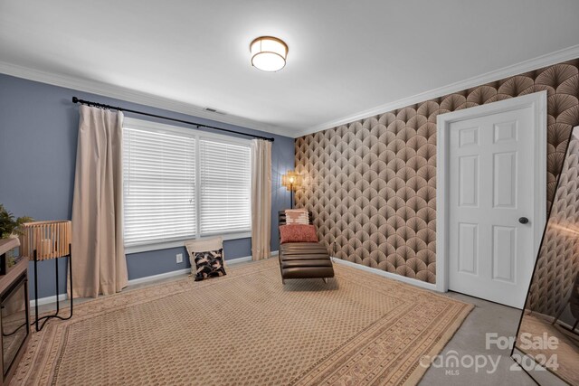 living area with crown molding and carpet