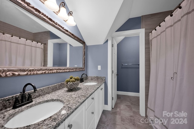 bathroom with lofted ceiling and vanity