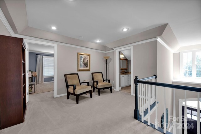 sitting room featuring an upstairs landing, baseboards, light colored carpet, and recessed lighting