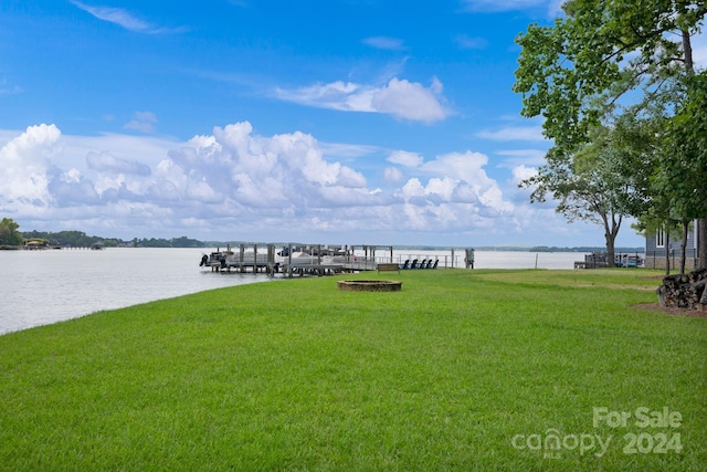 exterior space featuring a water view and a yard