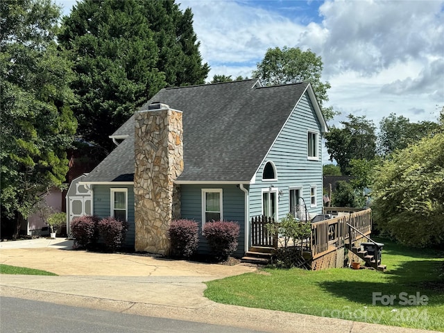 view of front of house featuring a front yard and a wooden deck