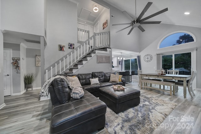 living room featuring ceiling fan, high vaulted ceiling, and hardwood / wood-style flooring