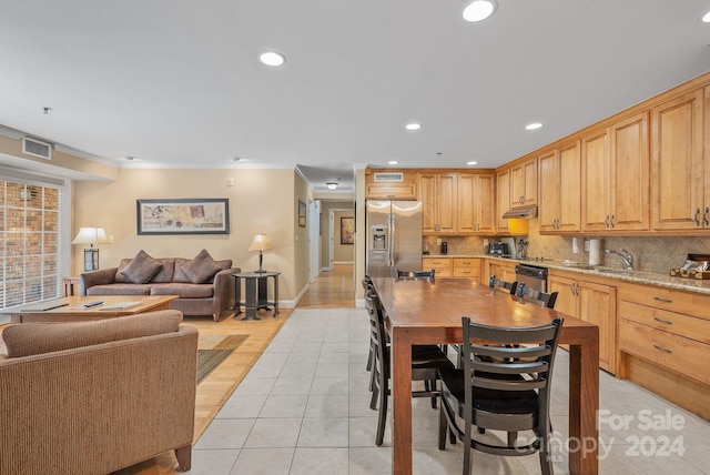 dining room featuring crown molding, light tile patterned floors, recessed lighting, and baseboards