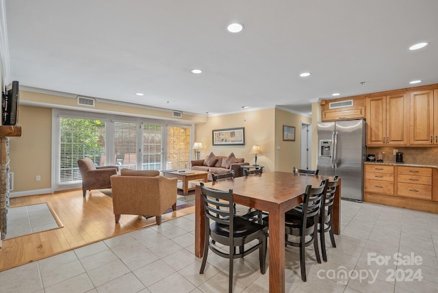 dining area with recessed lighting, visible vents, light tile patterned flooring, and crown molding