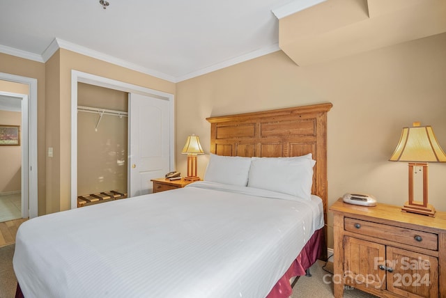 bedroom featuring a closet, baseboards, and crown molding