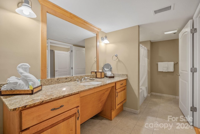 bathroom featuring vanity, tile patterned floors, baseboards, and visible vents