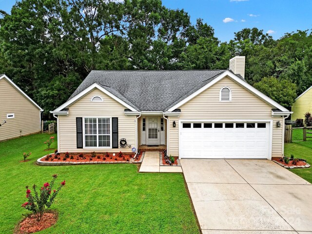 ranch-style house with a garage and a front lawn