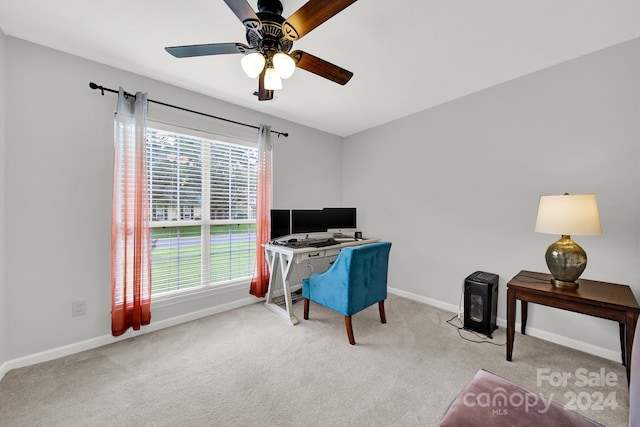 carpeted home office featuring ceiling fan and plenty of natural light