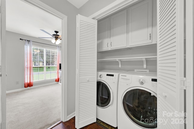 clothes washing area featuring independent washer and dryer, dark carpet, cabinets, and ceiling fan