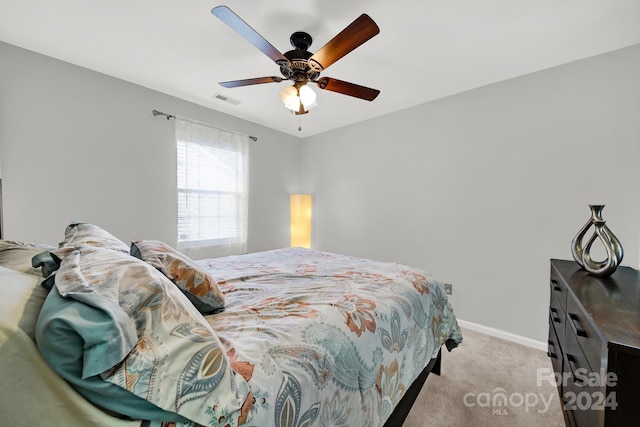 carpeted bedroom featuring ceiling fan