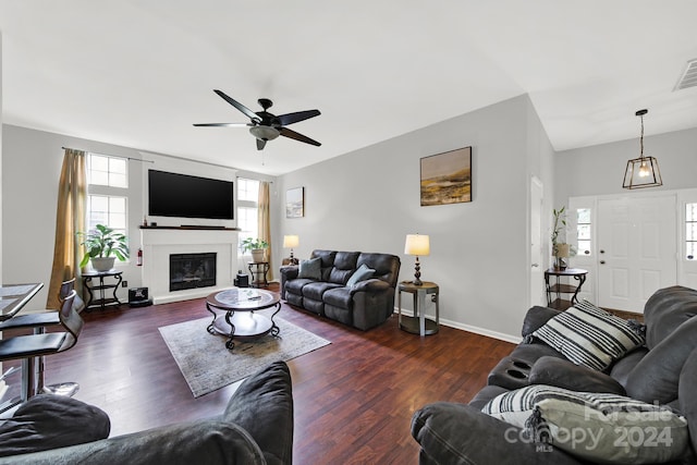 living room with dark hardwood / wood-style flooring and ceiling fan