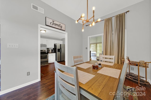 dining space with a chandelier and dark hardwood / wood-style flooring