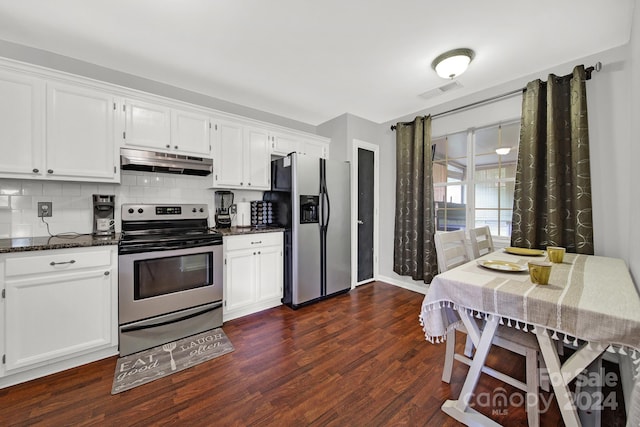 kitchen featuring white cabinetry, decorative backsplash, dark stone countertops, appliances with stainless steel finishes, and dark wood-type flooring